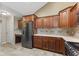 Kitchen with wood cabinetry, tile backsplash, and stainless steel appliances at 1098 Extraordinary Trl, Greenfield, IN 46140