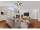 Bright staged living room features hardwood floors, a fireplace, and high ceilings with an arched window at 1098 Extraordinary Trl, Greenfield, IN 46140
