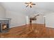 Bright living room features hardwood floors and fireplace with views to kitchen and other rooms at 1098 Extraordinary Trl, Greenfield, IN 46140