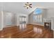 Bright living room features hardwood floors, a fireplace, and high ceilings with a fan and arched window at 1098 Extraordinary Trl, Greenfield, IN 46140