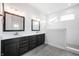 Bathroom features double sinks, dark wood cabinets, and subway tile shower at 11338 Briargate Dr, Fishers, IN 46055