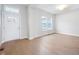 Bright foyer with hardwood floors, a modern light fixture, and large windows providing ample natural light at 11338 Briargate Dr, Fishers, IN 46055