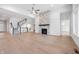 Open floor plan shows living room with hardwood floors, fireplace and access to the stairs and other rooms at 11338 Briargate Dr, Fishers, IN 46055