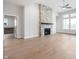 Open-concept living room features a stone fireplace, hardwood floors, high ceilings, and natural light at 11338 Briargate Dr, Fishers, IN 46055