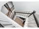 Carpeted staircase with dark wood railing and white spindles connecting multiple levels at 11338 Briargate Dr, Fishers, IN 46055