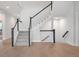 Staircase with carpeted treads and black handrail and white balusters leading to the upper level of the house at 11338 Briargate Dr, Fishers, IN 46055