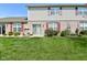 View of the backyard, including a lush lawn and a patio area with chairs, ideal for outdoor enjoyment at 1175 Bent Tree Way, Plainfield, IN 46168