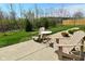 Relaxing backyard patio with Adirondack chairs and a table, perfect for outdoor living and entertaining at 1175 Bent Tree Way, Plainfield, IN 46168