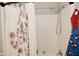 Bright bathroom showcasing a shower-tub combo, neutral walls, and a decorative shower curtain at 1175 Bent Tree Way, Plainfield, IN 46168