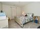 Bright bedroom featuring a cozy bed with patterned quilt, neutral walls, and a window with light-filtering curtains at 1175 Bent Tree Way, Plainfield, IN 46168