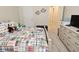 Cozy bedroom featuring neutral walls, plush carpet, and a comfortable bed with a playful, colorful patterned quilt at 1175 Bent Tree Way, Plainfield, IN 46168