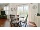 Bright dining area with natural light from sliding glass door with a round table and seating for four at 1175 Bent Tree Way, Plainfield, IN 46168