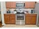 Kitchen featuring stainless steel oven, range, microwave, and stone countertops at 1175 Bent Tree Way, Plainfield, IN 46168