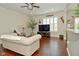 Living room with ceiling fan and hardwood floors, open layout flows to the kitchen at 1175 Bent Tree Way, Plainfield, IN 46168
