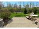 Cozy patio with a chair, small table, and serene view of the backyard at 1175 Bent Tree Way, Plainfield, IN 46168