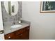 Elegant powder room featuring granite countertop and decorative wallpaper at 1175 Bent Tree Way, Plainfield, IN 46168