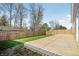 View of the backyard with a concrete patio and wood fence, perfect for outdoor living at 122 Winding Brook Way, Pendleton, IN 46064