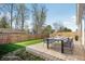 Backyard patio area featuring a modern dining table and a privacy fence at 122 Winding Brook Way, Pendleton, IN 46064