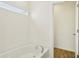 White bathroom featuring a tiled tub and modern fixtures at 122 Winding Brook Way, Pendleton, IN 46064