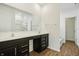 Bathroom featuring dual sinks, dark cabinets, a large mirror, and a separate shower and tub at 122 Winding Brook Way, Pendleton, IN 46064