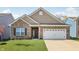 Charming home boasts brick and vinyl siding and an attached two car garage at 122 Winding Brook Way, Pendleton, IN 46064