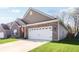 Spacious two-car garage on a single Gathering home with brick and siding at 122 Winding Brook Way, Pendleton, IN 46064
