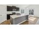 Modern kitchen featuring stainless steel appliances, a center island, and dark cabinets at 122 Winding Brook Way, Pendleton, IN 46064