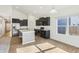 Modern kitchen features stainless steel appliances, dark cabinets, and a center island with a sink at 122 Winding Brook Way, Pendleton, IN 46064