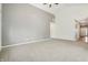 Spacious living room featuring plush carpeting, ceiling fan, and neutral paint palette at 122 Winding Brook Way, Pendleton, IN 46064