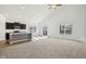 Open-concept living space with kitchen island, carpeted living room, and natural light at 122 Winding Brook Way, Pendleton, IN 46064