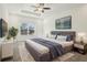 Stylishly decorated main bedroom with plush carpeting, tray ceiling, and a large window at 122 Winding Brook Way, Pendleton, IN 46064