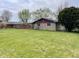 Spacious backyard highlighting a lush lawn and a charming stone facade, perfect for outdoor relaxation at 1221 S Catherwood Ave, Indianapolis, IN 46203