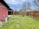 Well-maintained backyard with a privacy fence, an AC unit, and a grassy area, perfect for outdoor relaxation at 1221 S Catherwood Ave, Indianapolis, IN 46203