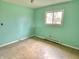 Bedroom with light green walls, window, and radiator, offering a cozy space with natural light at 1221 S Catherwood Ave, Indianapolis, IN 46203