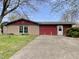 Charming single-Gathering home with a stone and red-sided facade, a tidy lawn, and a concrete driveway at 1221 S Catherwood Ave, Indianapolis, IN 46203