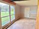 Spacious living room with large windows and wainscoting, offering lots of natural light at 1221 S Catherwood Ave, Indianapolis, IN 46203
