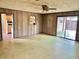 Retro living room leads to the backyard and features wood-paneled walls at 1221 S Catherwood Ave, Indianapolis, IN 46203
