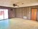 The living room has retro wood-paneled walls and sliding glass doors at 1221 S Catherwood Ave, Indianapolis, IN 46203
