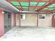 Covered patio showcasing stone walls, a cement floor, offering an ideal space for outdoor living and entertaining at 1221 S Catherwood Ave, Indianapolis, IN 46203