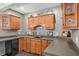 Wet bar area with hardwood cabinets, countertop seating, storage and stainless steel dishwasher at 12372 Ostara Ct, Fishers, IN 46037