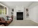 Finished basement with built-in shelving, a cozy leather couch, and natural light at 12372 Ostara Ct, Fishers, IN 46037