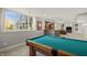 Finished basement with a pool table, bar area, recessed lighting and large daylight window at 12372 Ostara Ct, Fishers, IN 46037
