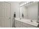 Bright bathroom with a double sink vanity, large mirror and neutral color palette throughout at 12372 Ostara Ct, Fishers, IN 46037