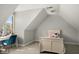 Cozy bedroom with a sloped ceiling, featuring a comfortable bed and dedicated space for a desk at 12372 Ostara Ct, Fishers, IN 46037