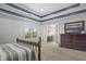 Spacious primary bedroom features a decorative ceiling, and french doors leading to a spa-like bathroom at 12372 Ostara Ct, Fishers, IN 46037