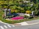 Stone community entrance sign surrounded by colorful landscaping and lush greenery at 12372 Ostara Ct, Fishers, IN 46037
