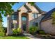 Brick home featuring an arched entryway, well-manicured lawn, and welcoming front door decor at 12372 Ostara Ct, Fishers, IN 46037