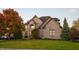 Charming two-story brick home with a well-manicured lawn and mature trees at 12372 Ostara Ct, Fishers, IN 46037
