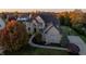 Beautiful brick home featuring an arched entryway, well-manicured lawn, and a basketball court at 12372 Ostara Ct, Fishers, IN 46037