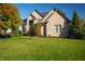 Beautiful brick home with mature landscaping, a well-manicured lawn, and a welcoming facade at 12372 Ostara Ct, Fishers, IN 46037